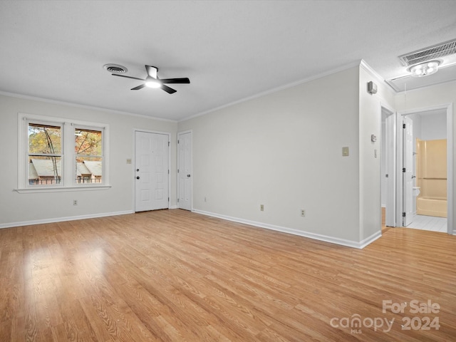 empty room featuring ceiling fan, light hardwood / wood-style floors, and ornamental molding