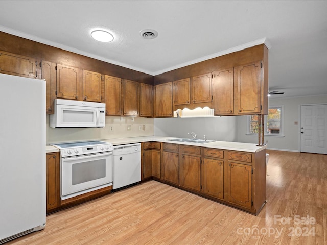 kitchen with ceiling fan, sink, light hardwood / wood-style flooring, kitchen peninsula, and white appliances