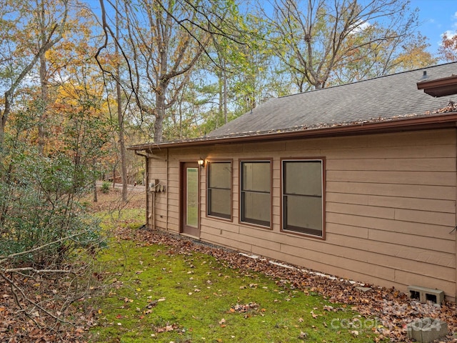 view of property exterior with a yard