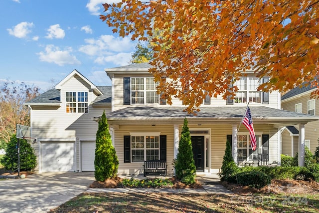 view of front of home featuring a porch and a garage