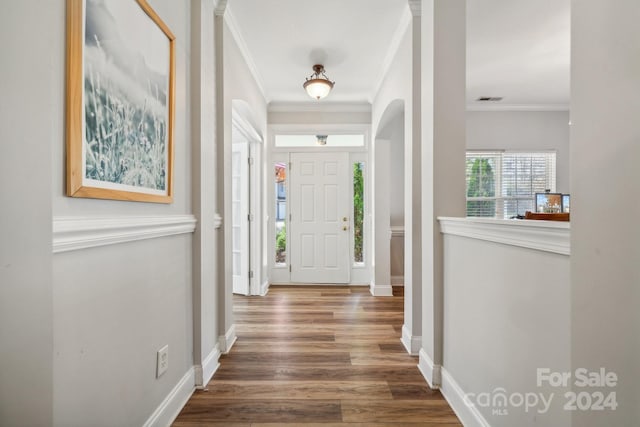 entrance foyer with hardwood / wood-style flooring and ornamental molding