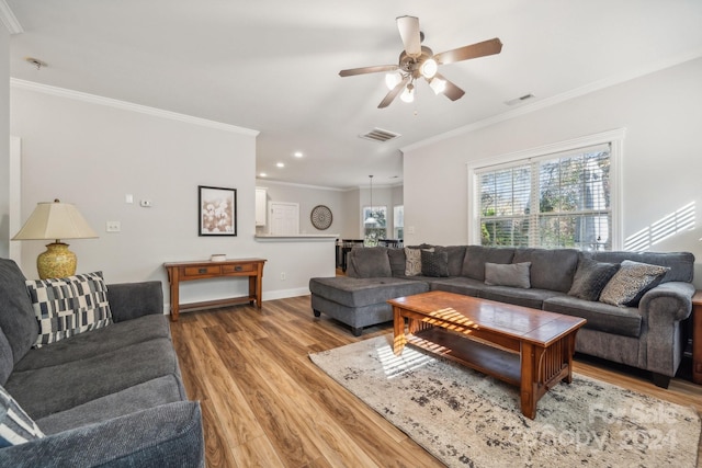 living room with hardwood / wood-style floors, ceiling fan, and ornamental molding