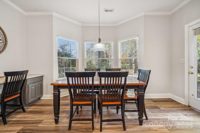 dining room featuring wood-type flooring and ornamental molding