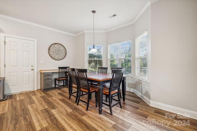 dining room featuring crown molding and hardwood / wood-style floors