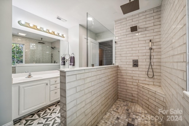 bathroom featuring vanity and a tile shower