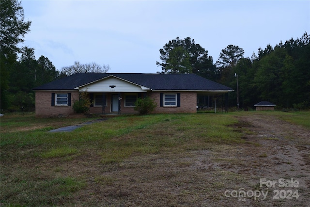 single story home featuring a carport and covered porch