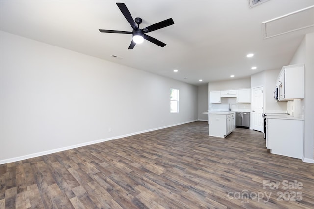 unfurnished living room featuring ceiling fan and dark wood-type flooring