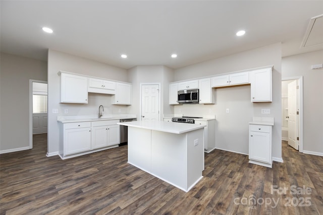 kitchen with white cabinets, stainless steel appliances, and a kitchen island