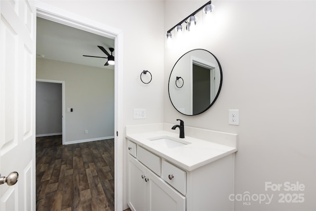 bathroom with ceiling fan, hardwood / wood-style floors, and vanity