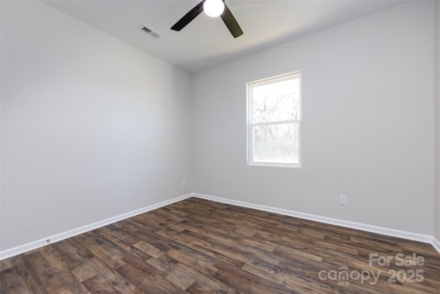 unfurnished room with ceiling fan and dark wood-type flooring