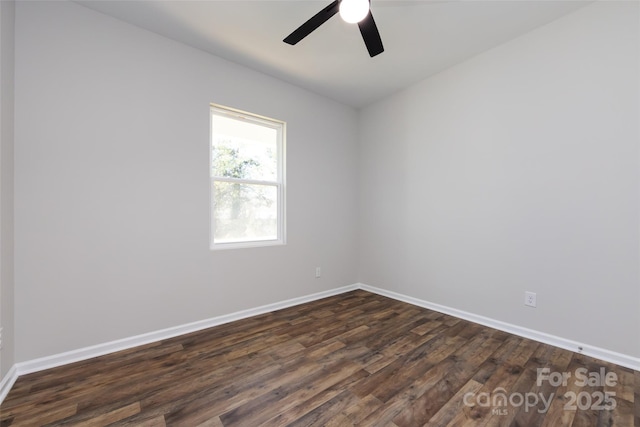 empty room featuring ceiling fan and dark hardwood / wood-style flooring