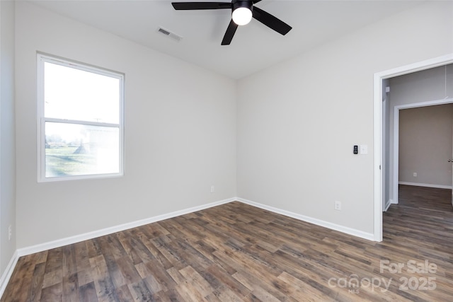 empty room featuring dark hardwood / wood-style floors, ceiling fan, and a healthy amount of sunlight