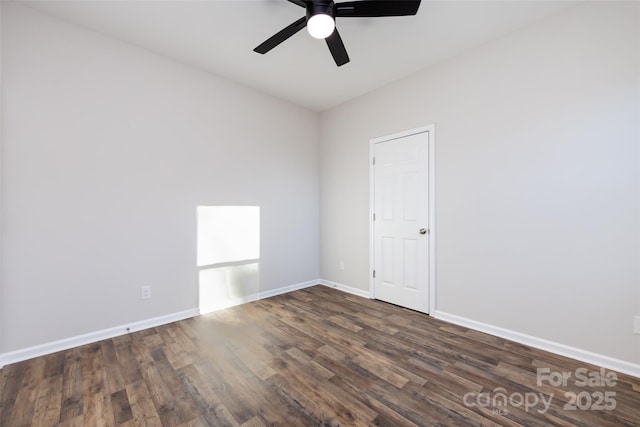 empty room with ceiling fan and dark wood-type flooring