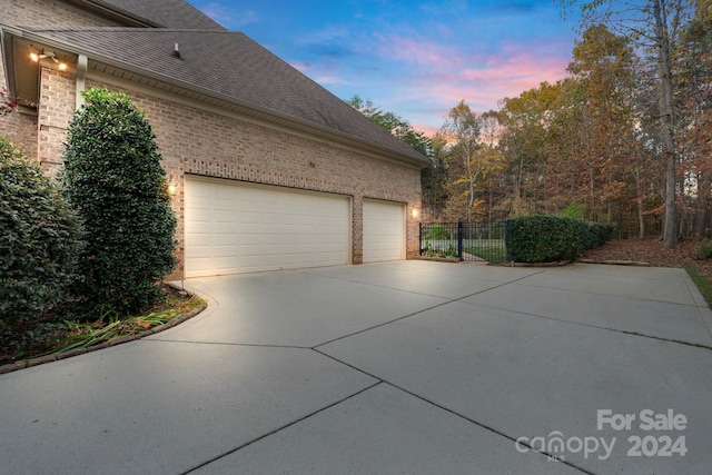 property exterior at dusk featuring a garage