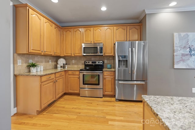 kitchen featuring crown molding, light hardwood / wood-style flooring, decorative backsplash, light stone counters, and stainless steel appliances