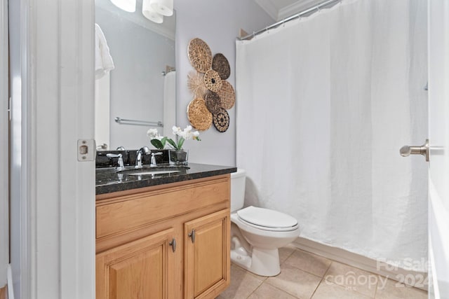 bathroom featuring tile patterned floors, vanity, and toilet