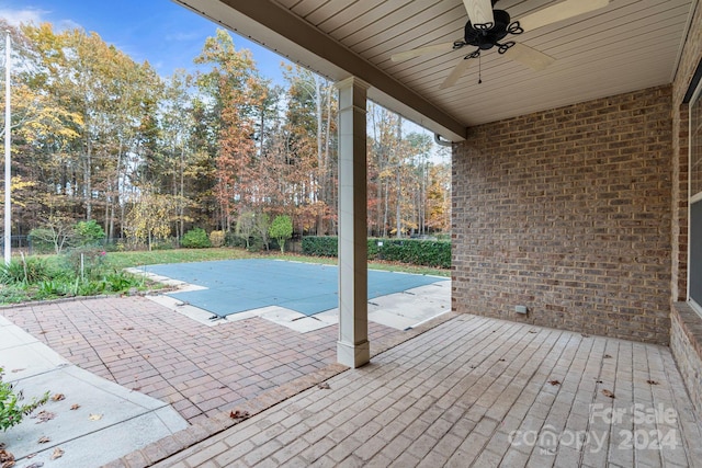 view of swimming pool with a patio and ceiling fan