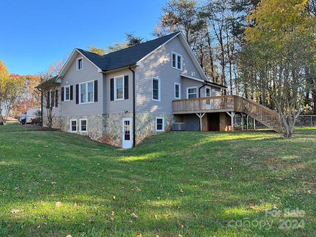 view of property exterior featuring a lawn, cooling unit, and a deck