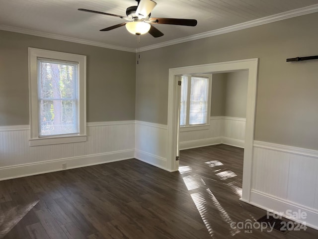 4541 Hall Dairy Rd, Claremont, NC 28610 - spare room with plenty of natural light, a wainscoted wall, a ceiling fan, dark wood-style flooring, and crown molding