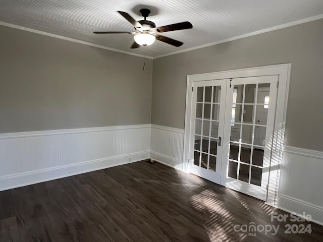 spare room featuring dark hardwood / wood-style floors, crown molding, and french doors