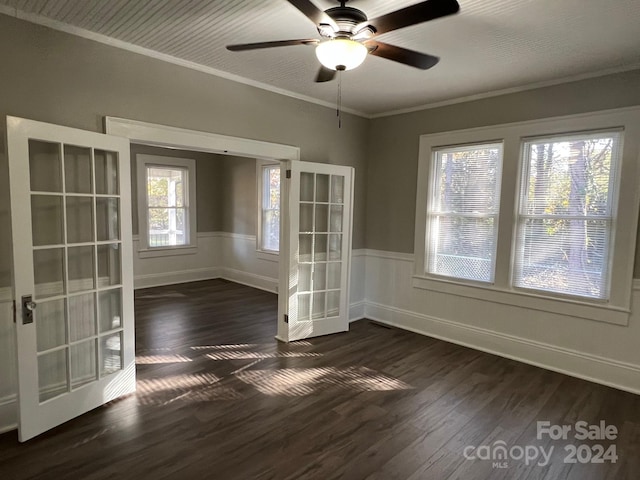 unfurnished room featuring ceiling fan, dark hardwood / wood-style flooring, crown molding, and french doors