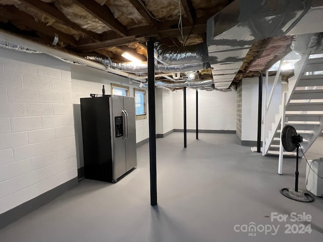 4541 Hall Dairy Rd, Claremont, NC 28610 - below grade area featuring stainless steel fridge, stairway, and concrete block wall