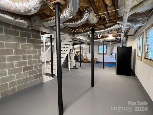 4541 Hall Dairy Rd, Claremont, NC 28610 - below grade area featuring stairway, freestanding refrigerator, and concrete block wall