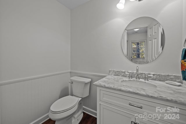 bathroom featuring vanity, toilet, and wood-type flooring