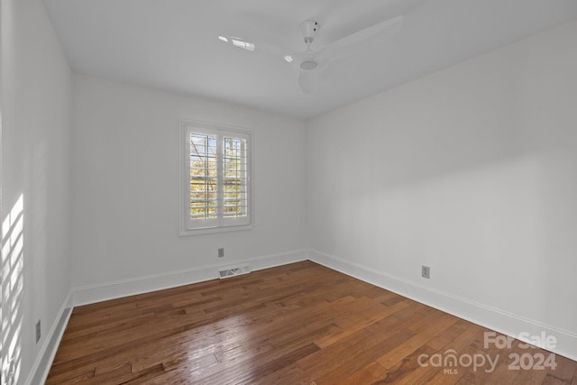 spare room with hardwood / wood-style flooring and ceiling fan