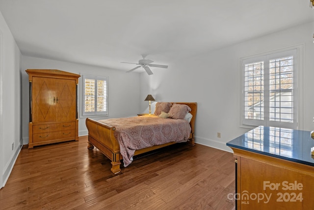 bedroom with hardwood / wood-style flooring, multiple windows, and ceiling fan