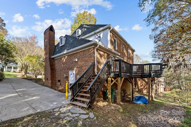 rear view of property with a wooden deck