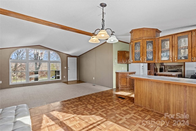 kitchen featuring lofted ceiling, light parquet floors, decorative light fixtures, a textured ceiling, and tile counters