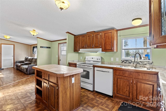 kitchen featuring a textured ceiling, tile countertops, sink, and white appliances