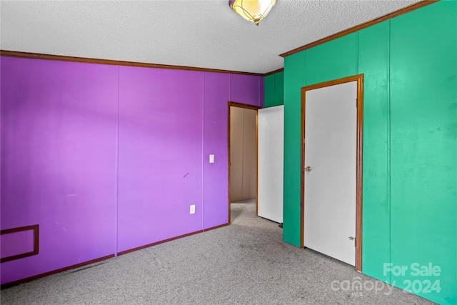 unfurnished bedroom with light carpet, crown molding, and a textured ceiling