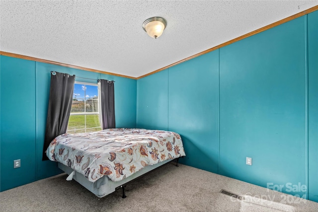 carpeted bedroom featuring a textured ceiling