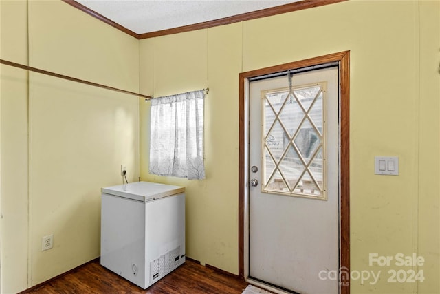 laundry area with dark hardwood / wood-style flooring and ornamental molding