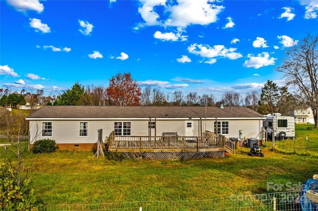 rear view of property featuring a lawn, a wooden deck, and central AC unit