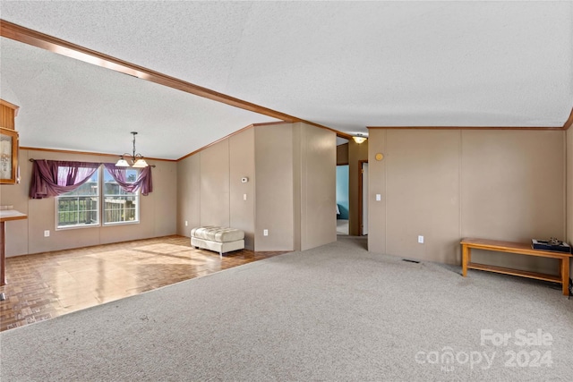 unfurnished living room featuring lofted ceiling, ornamental molding, a textured ceiling, and light carpet