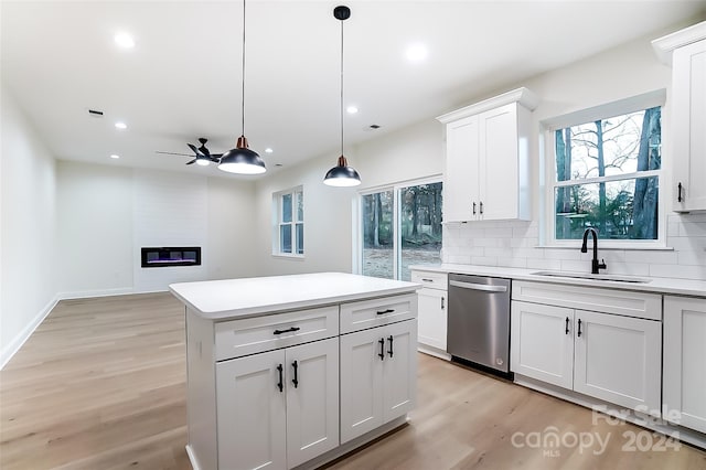 kitchen with pendant lighting, dishwasher, sink, light wood-type flooring, and white cabinetry