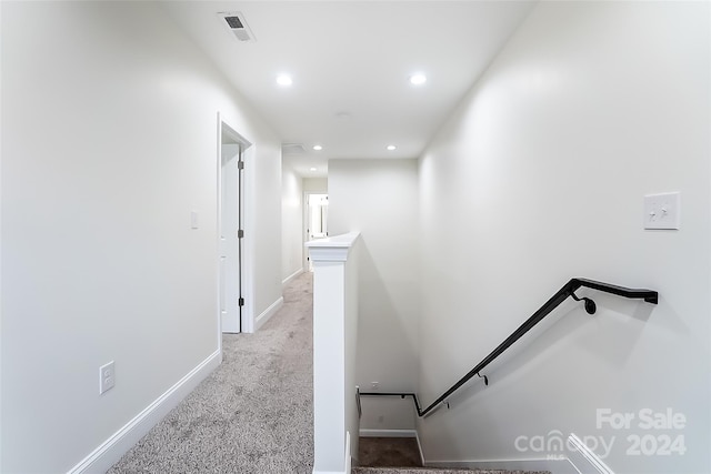 corridor with light colored carpet