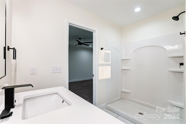 bathroom featuring tile patterned flooring, vanity, and walk in shower