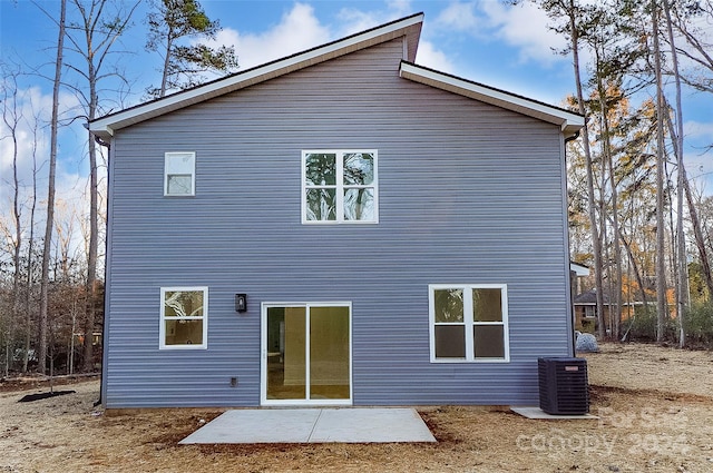 rear view of property featuring a patio and cooling unit