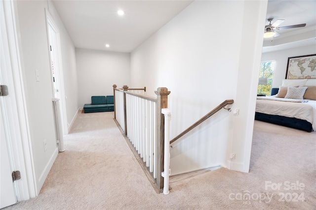 hallway featuring light carpet