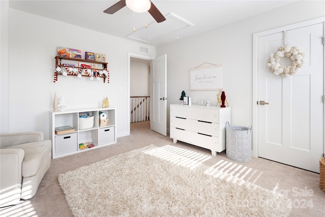 interior space featuring ceiling fan and light carpet