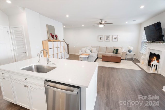 kitchen with dark wood-type flooring, sink, stainless steel dishwasher, an island with sink, and white cabinetry