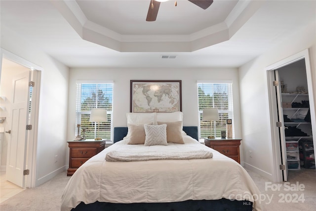 bedroom with multiple windows, a spacious closet, a closet, and ceiling fan