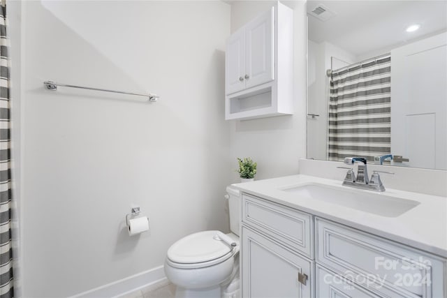 bathroom featuring tile patterned flooring, vanity, toilet, and a shower with shower curtain