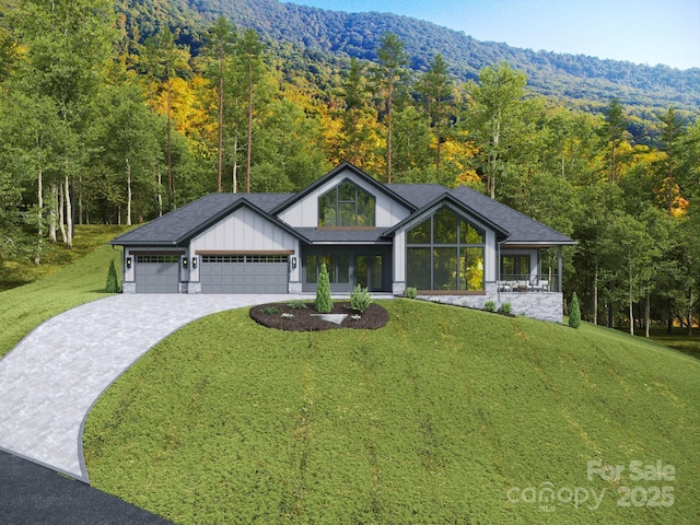 3 Bridgeway Dr Unit 38, Candler, NC 28715 - view of front facade featuring a view of trees, a garage, a front lawn, and driveway