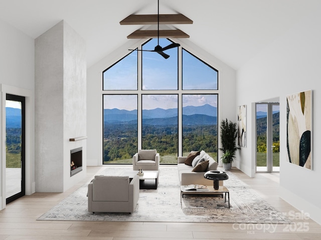 3 Bridgeway Dr Unit 38, Candler, NC 28715 - living area featuring high vaulted ceiling, a mountain view, wood finished floors, ceiling fan, and a fireplace