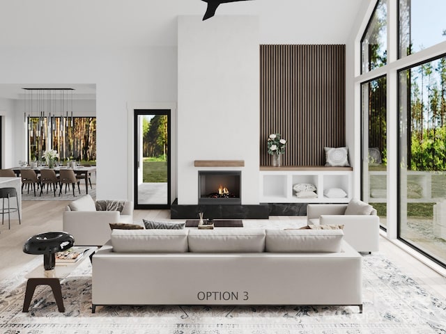 3 Bridgeway Dr Unit 38, Candler, NC 28715 - living area featuring wood finished floors, a towering ceiling, and a lit fireplace
